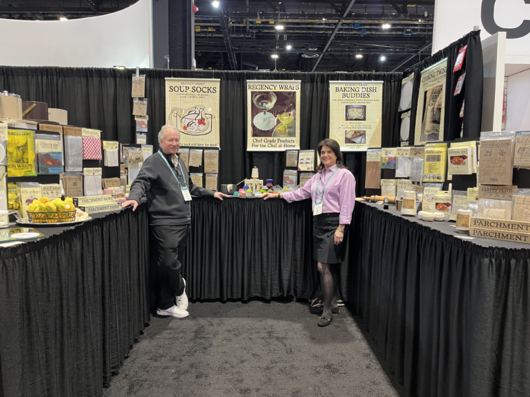 Doug and Lori Cohen, the husband and wife team that owns and runs the Dallas-based cooking accessory company Regency Wraps, in front of their display space at the Inspired Home Show in Chicago.