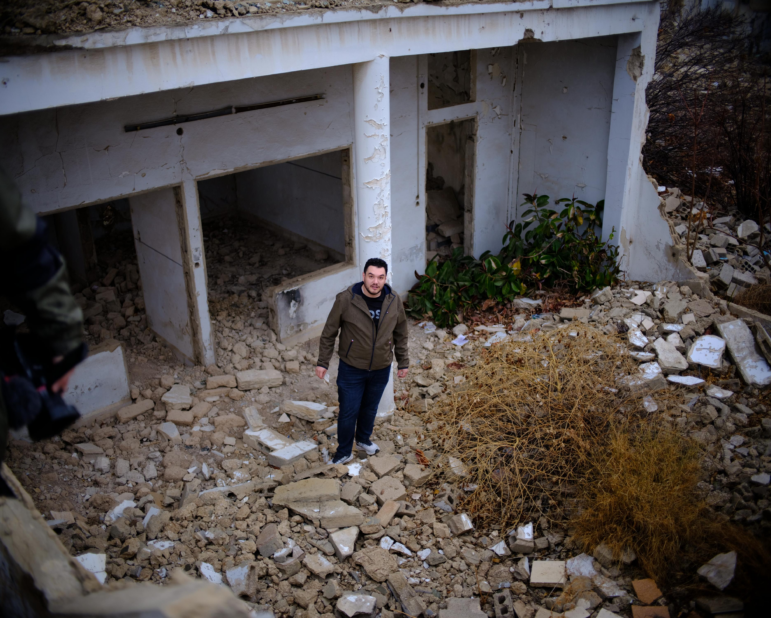 Abdulwahab Omira, 28, stands in front of his destroyed family home in Damascus, Syria. Omira and his family fled Syria's civil war in 2012 when he was a teenager. Now a U.S. citizen and a graduate student at Stanford, Omira recently returned to his home country to look for ways the tech industry could help rebuild it.