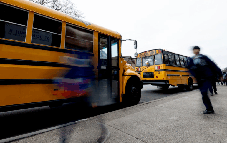 Students walk to their buses at the end of the school day in Minneapolis, Minn. Minnesota, Illinois and Wisconsin are among the states pushing back on the U.S. Education Department's DEI directive.