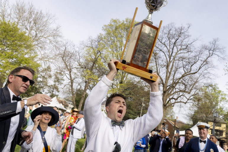 U.S. Naval Academy croquet team Imperial Wicket Liam Wert holds the trophy above his head