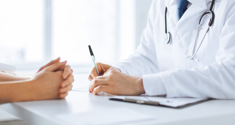 A patient and doctor taking notes