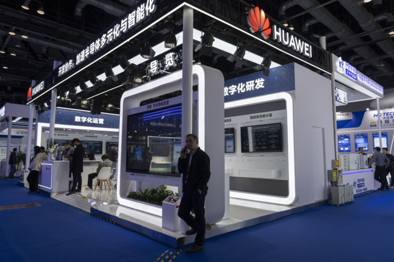 A man chats on his phone at the booth for Huawei at the 21st China International Semiconductor Expo in Beijing, in November 2024.