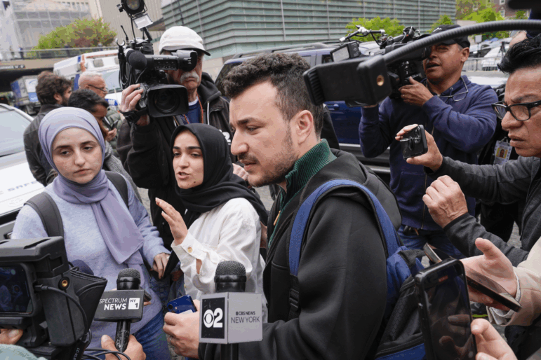 Mahmoud Khalil, center, and his wife Noor Abdalla, left, in violet headscarf, at Columbia University last year.