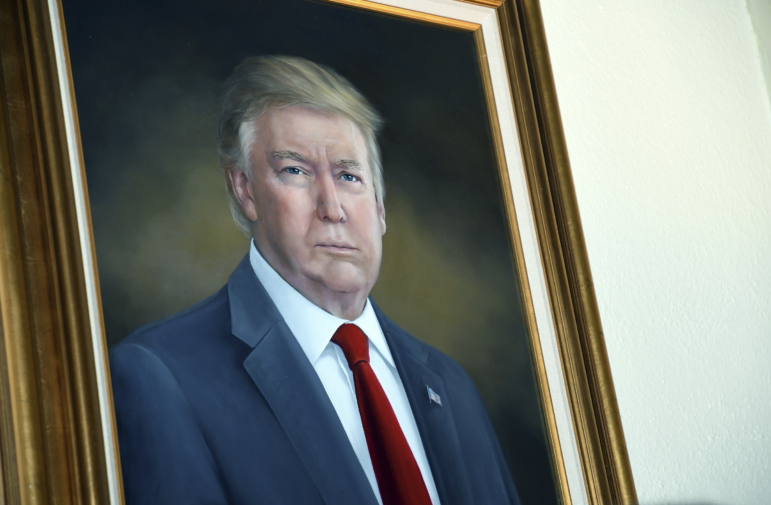 FILE - President Donald Trump's portrait hangs in the Colorado Capitol after an unveiling ceremony, Aug. 1, 2019, in Denver. (AP Photo/Thomas Peipert, File)
