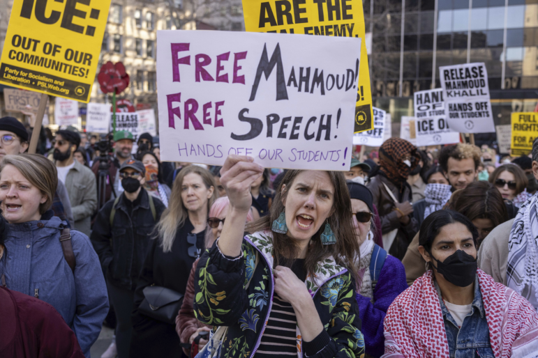 In this photo, protesters attending a demonstration hold signs declaring support for Mahmoud Khalil.