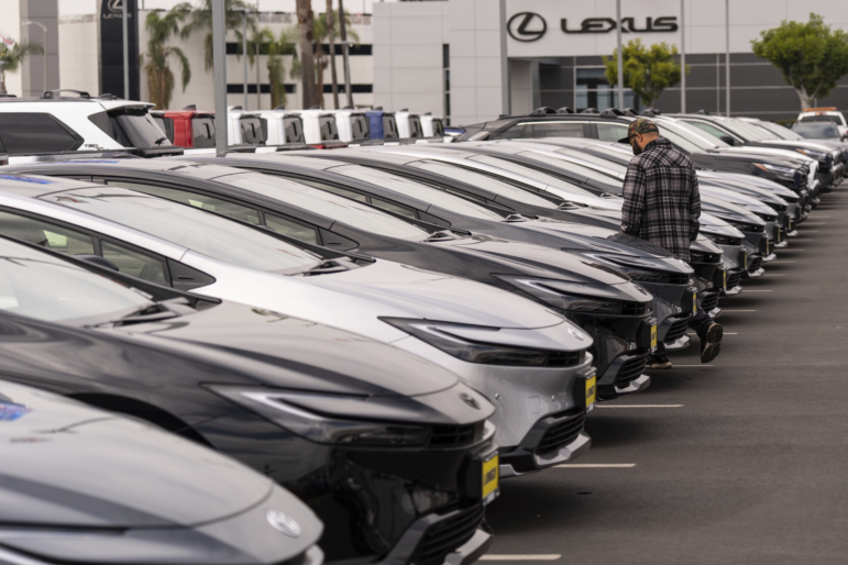 A person looks at a new vehicle at a Toyota dealership in El Monte, Calif., on Thursday, the day the 25% car import tariff went into effect in the U.S.
