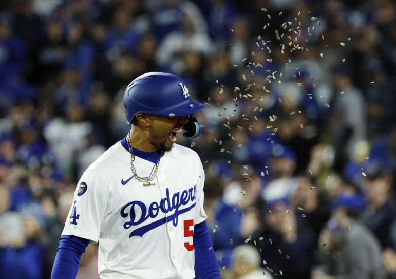 Los Angeles Dodgers' Mookie Betts is showered with sunflower seeds after hitting a two-run home run against the Atlanta Braves during the sixth inning of a baseball game on Tuesday in Los Angeles.