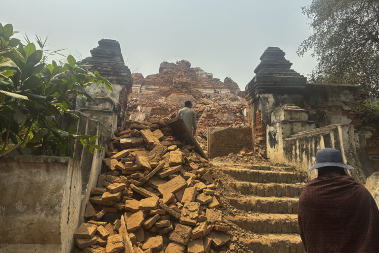 Visitors walk near damaged Maha Aungmye Bonzan Monastery, commonly known as the Me Nu Brick Monastery, in the aftermath of Friday's earthquake in Innwa, Tada-U township, Mandalay, Myanmar on Friday.
