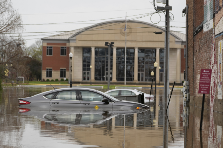 Cars sit in a flooded street in Hopkinsville, Ky., on Friday.
