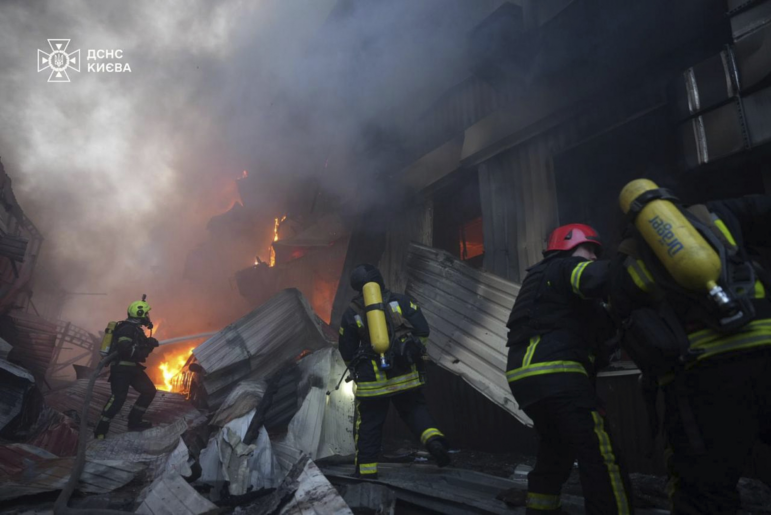 In this photo provided by the Ukrainian Emergency Service, emergency services personnel work to extinguish a fire following a Russian missile attack in Kyiv, Ukraine, Sunday, April 6, 2025.