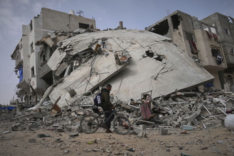 A man passes by the destroyed house of journalist Islam Meqdad, where she was killed along with her son and five other family members in an Israeli army strike in Khan Younis, southern Gaza Strip, Sunday, April 6, 2025.