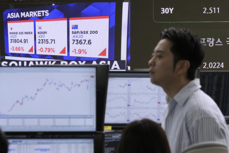 Asia markets index of Japan, South Korea and Australia is seen on a screen as a currency trader works at the foreign exchange dealing room of the KEB Hana Bank headquarters in Seoul, South Korea, Wednesday, April 9, 2025.