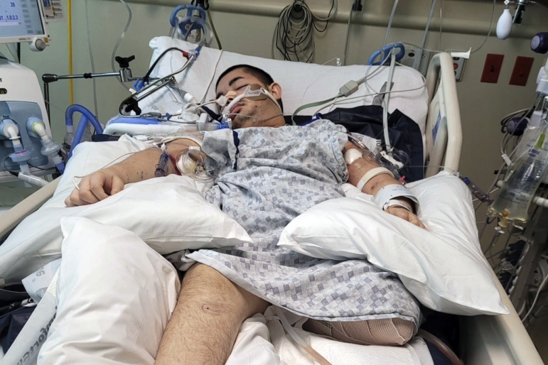 This photo provided by Ana L Vazquez, shows Victor Perez in a hospital bed in Pocatello, Idaho.