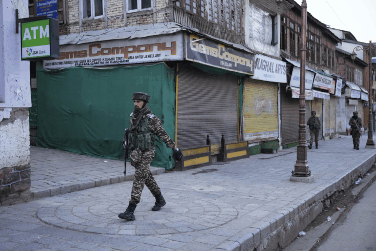 An Indian security officer patrols a shopping area in Pahalgam a day after militants indiscriminately opened fire on tourists near the town, Indian controlled Kashmir on Wednesday.
