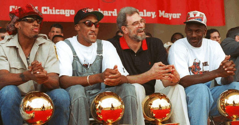 Chicago Bulls Dennis Rodman, Scottie Pippen, coach Phil Jackson and Michael Jordan celebrating their 4th NBA championship in 1996. Chicago's dominance of basketball in the 1990s established the Bulls as a cultural force and worldwide brand.