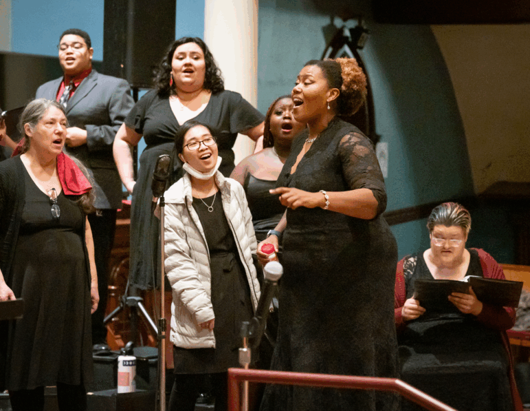 Coty Raven Morris conducts the combined Rose and Thorn Choirs singing an African piece called "Modimo" at the From the Dust concert performed at First Congregational Church in Portland in November, 2023.