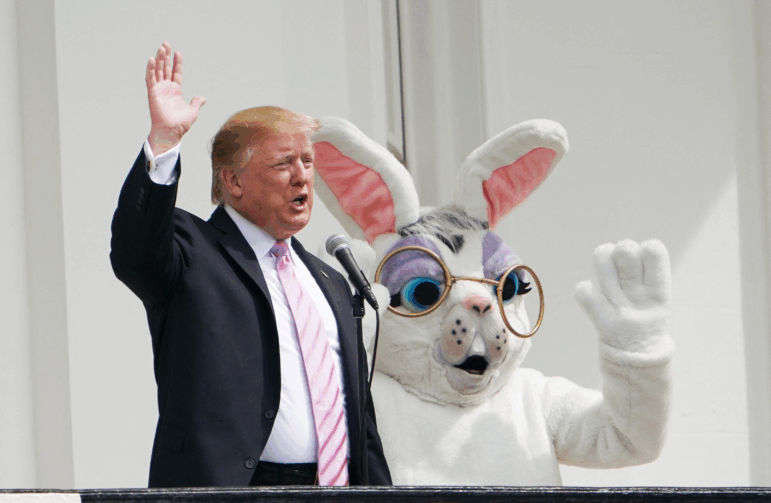 President Trump and the Easter Bunny wave during the annual White House Easter Egg Roll on the South Lawn on April 22, 2019.