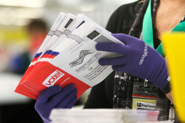 An election worker sorts vote-by-mail ballots for the presidential primary at King County Elections in Renton, Wash., in March 2020.