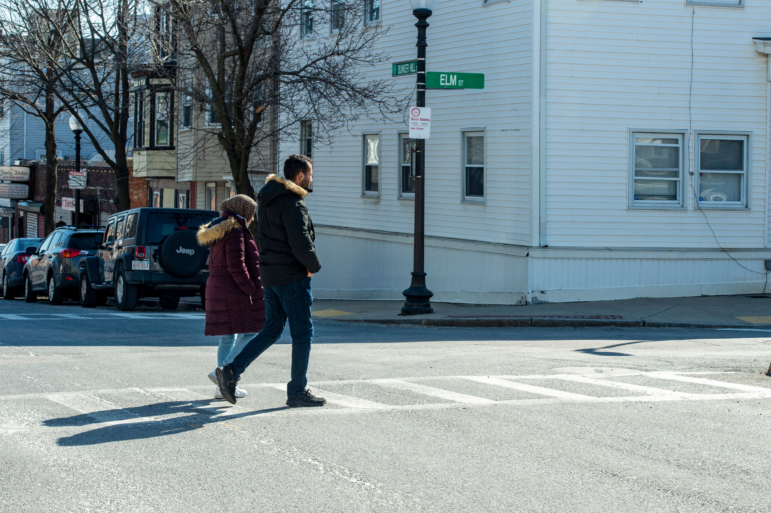 Afghani evacuees walk to a dentist appointment in Charlestown, Mass.