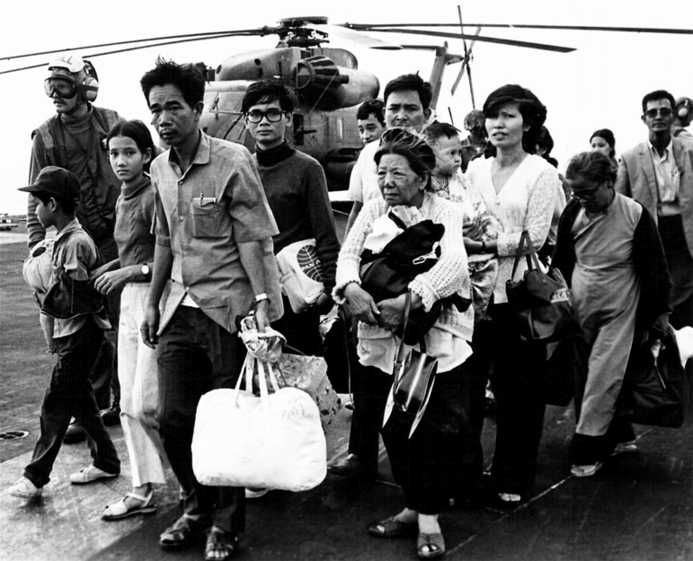 The Fall of Saigon was the capture of Saigon, the capital of South Vietnam, by the People's Army of Vietnam and the National Liberation Front of South Vietnam (also known as the Viet Cong) on April 30, 1975. The event marked the end of the Vietnam War and the start of a transition period leading to the formal reunification of Vietnam into a Socialist Republic governed by the Communist Party. North Vietnamese forces under the command of the General Van Tien Dung began their final attack on Saigon, with South Vietnamese forces commanded by General Nguyen Van Toan, on April 29, suffering heavy artillery bombardment. By the afternoon of the next day, North Vietnamese troops had occupied the important points of the city and raised their flag over the South Vietnamese presidential palace. The South Vietnamese government capitulated shortly afterward. The city was renamed Ho Chi Minh City, after the Democratic Republic's President Ho Chi Minh. The fall of the city was preceded by the evacuation of almost all the American civilian and military personnel in Saigon, along with tens of thousands of South Vietnamese civilians associated with the southern regime. The evacuation culminated in Operation Frequent Wind, the largest helicopter evacuation in history. (Photo by: Pictures From History/Universal Images Group via Getty Images)