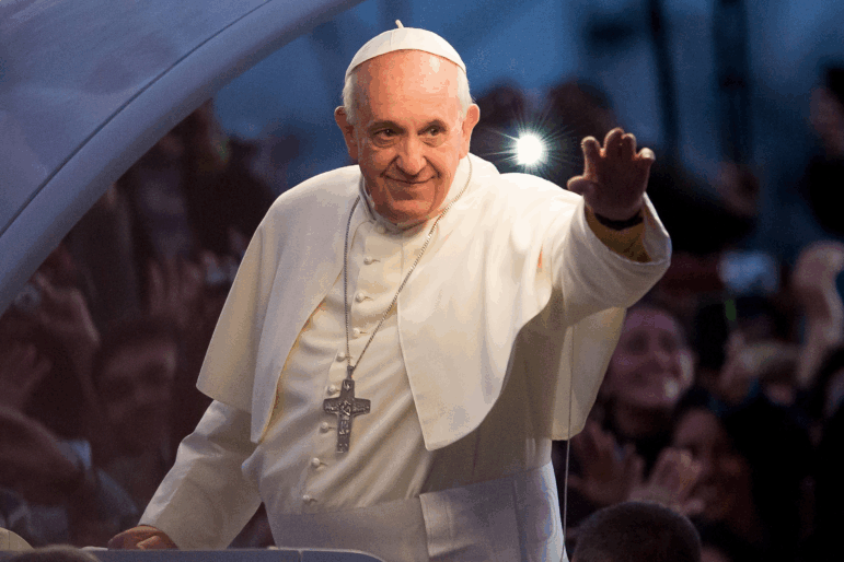 Pope Francis waves to thousands of followers as he arrives at the Manila Cathedral on January 16, 2015 in Manila, Philippines.