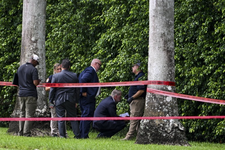 Law enforcement officials work at the crime scene outside the Trump International Golf Club in West Palm Beach, Fla., on September 16, 2024, following the attempted assassination on then-Republican presidential candidate Donald Trump. Ryan Routh is charged in the case and has a federal court hearing on Tuesday in Fort Pierce, Fla.