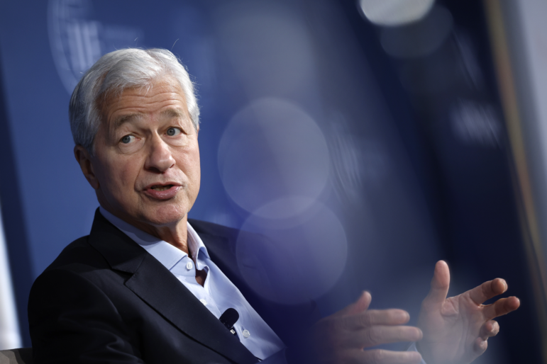 JPMorgan Chase CEO Jamie Dimon, pictured at a meeting in October, warned Monday that tariffs will raise prices, slow economic growth and hurt U.S. global standing.