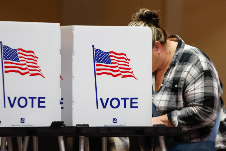 A woman votes at a polling location at The Chapel, an Evangelical church in St. Joseph, Mich., on Election Day, Nov. 5, 2024.
