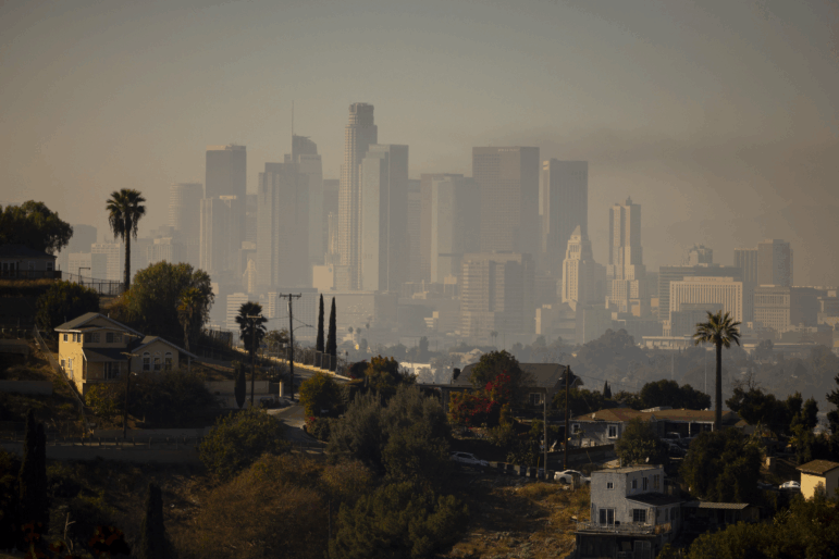 A layer of smog lingers above the downtown Los Angeles skyline in 2024. Millions of Americans are still breathing in unhealthy air, despite long-term progress toward cleaning up many sources of pollution over the years, according to the 2025 State of the Air report.