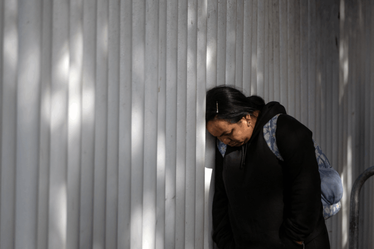An asylum seeker reacts while waiting for news on her appointment with U.S. authorities before crossing through El Chaparral port in Tijuana, Baja California state, Mexico, on Jan. 20, 2025.