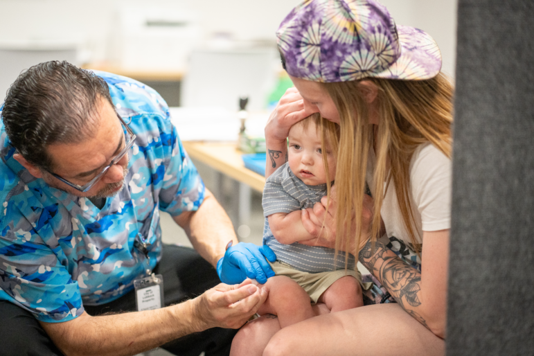 One-year-old River Jacobs is held by his mother, Caitlin Fuller, while he receives an MMR vaccine from Raynard Covarrubio, at a vaccine clinic held by the Lubbock Public Health Department on March 1 in Lubbock, Texas. A measles outbreak in West Texas has led to more than 500 cases, 57 hospitalizations and the deaths of two school-age children.