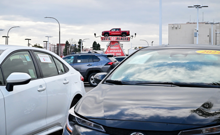 A pickup truck is raised for display at a car dealership in Alhambra, California, on March 27, 2025. After President Trump announced significant tariffs on imported vehicles and parts, automaker stocks fell sharply. But sales at dealerships rose, at least in the short-term, as buyers try to get ahead of the anticipated price spikes in the coming months.