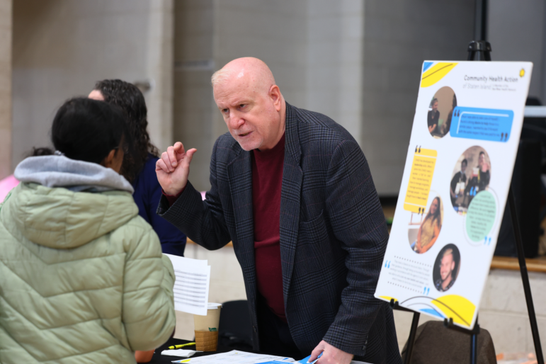Employers speak with attendees during a job fair at the YMCA Gerard Carter Center in Staten Island in New York City on March 27, 2025. Employers continued to add jobs in March, but uncertainty over trade policy and softer spending by consumers could soon be a drag on hiring.