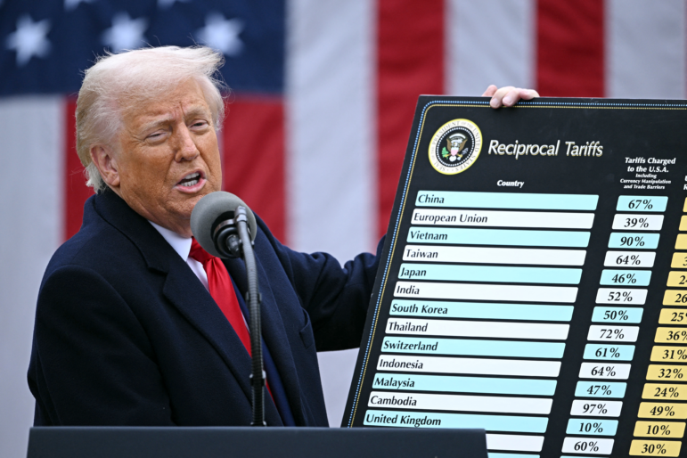 President Trump holds a chart as he delivers remarks on reciprocal tariffs.
