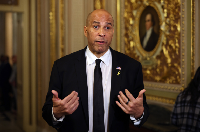 Sen. Cory Booker speaks to reporters as he leaves the Senate chamber after delivering a record-setting floor speech on Tuesday. Contrary to popular belief, the speech was not technically a filibuster.