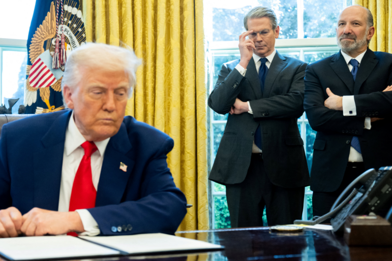 U.S. Treasury Secretary Scott Bessent (L) Commerce Secretary Howard Lutnick (R) look on as President Trump speaks in the Oval Office on Wednesday.