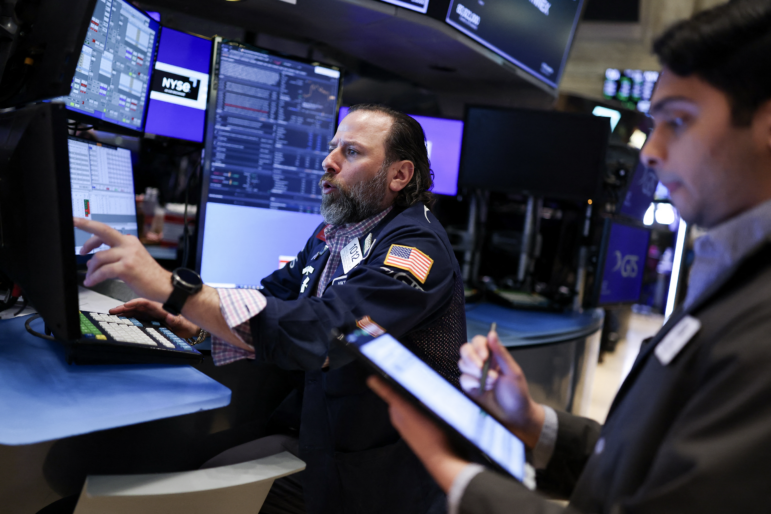 Traders work on the floor of the New York Stock Exchange (NYSE) at the opening bell on April 10, 2025, in New York City. Stocks resumed declines after gaining spectacularly a day earlier.