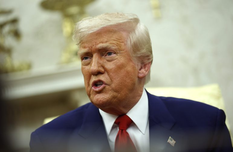 President Trump answers a reporter's question in the Oval Office on Monday. On Wednesday, the president said he was hiking tariffs on China to