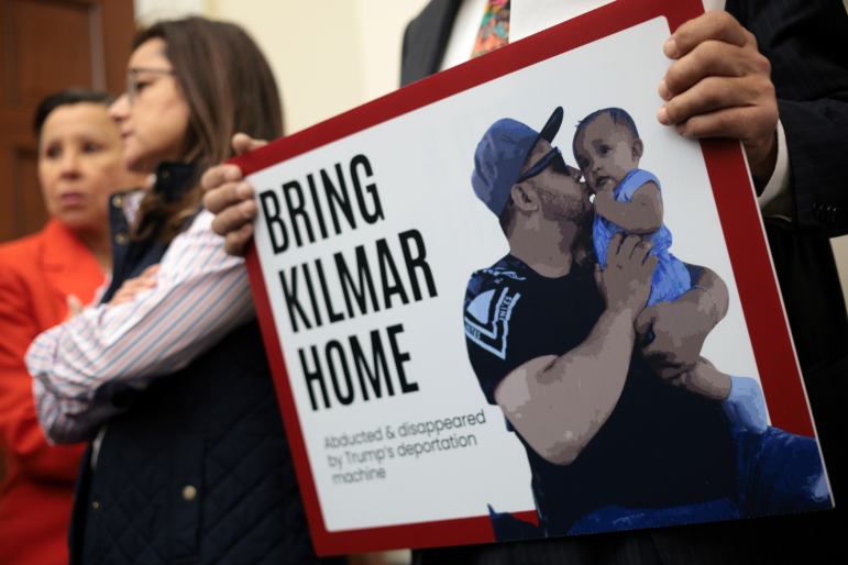 A member of the Congressional Hispanic Caucus holds a picture of Kilmar Abrego Garcia during a news conference to discuss Abrego Garcia's arrest and deportation on April 9, 2025 in Washington, D.C.
