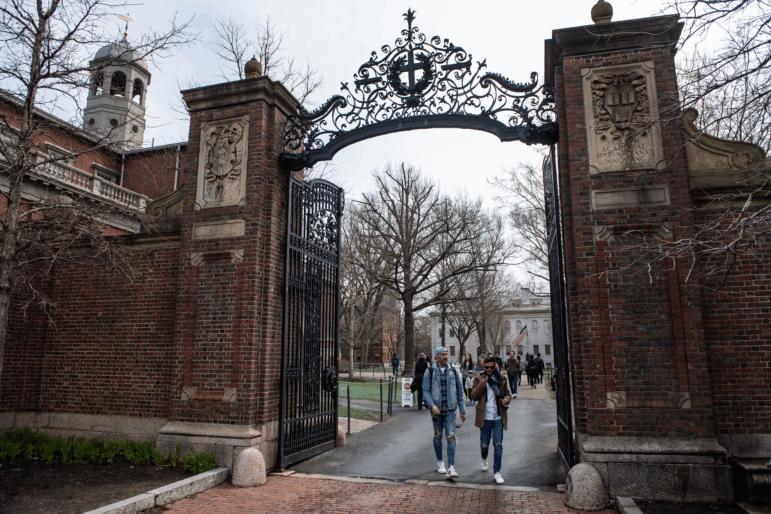 People walk through a gate as they exit Harvard Yard on the campus of Harvard University campus in Cambridge, Massachussetts, on April 15, 2025. Elite US university Harvard was hit with a $2.2 billion federal funding freeze on April 14 after rejecting a list of sweeping demands that the White House said was intended to crack down on campus anti-Semitism. The call for changes to its governance, hiring practices and admissions procedures expands a list Harvard received on April 3, which ordered officials to shut diversity offices and cooperate with immigration authorities for screenings of international students. In a letter to students and faculty, Harvard president Alan Garber vowed to defy the government, insisting that the school would not "negotiate over its independence or its constitutional rights." (Photo by Joseph Prezioso / AFP) (Photo by JOSEPH PREZIOSO/AFP via Getty Images)