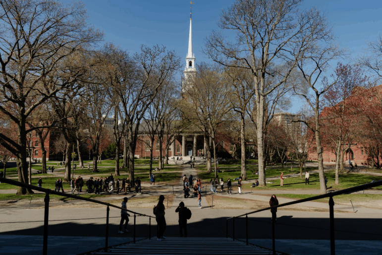 People cross Harvard Yard at Harvard University on April 17, in Cambridge, Mass.