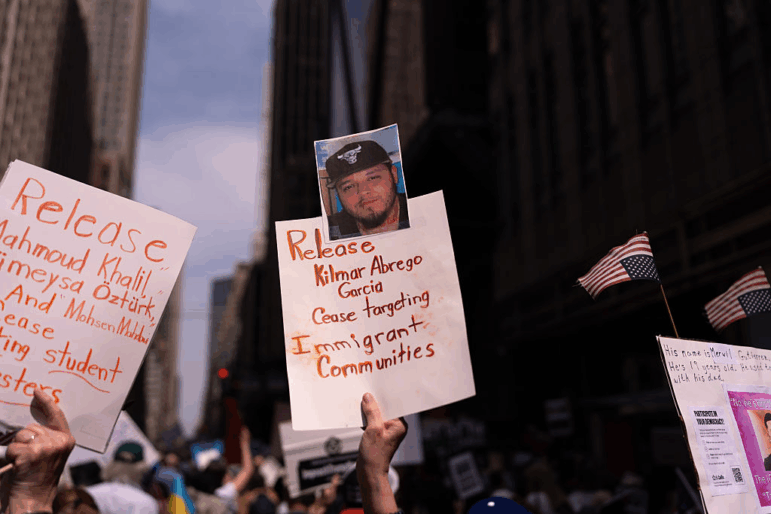 A person holds a sign with a photo of Kilmar Abrego Garcia at a protest in New York City.