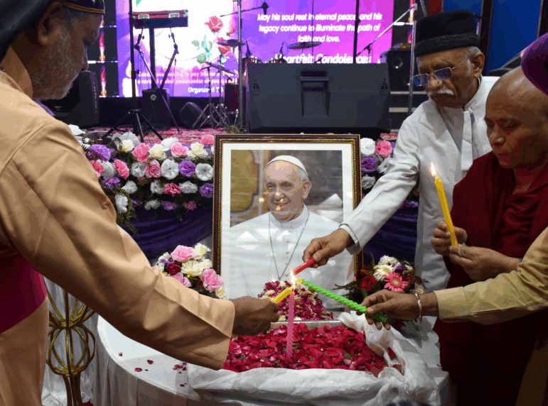 People attend an interfaith memorial meeting to mourn the death of Pope Francis in New Delhi, India, on Monday.