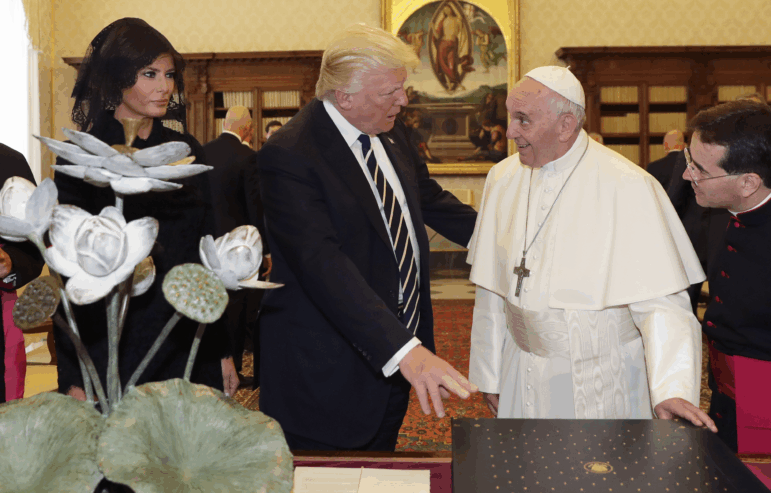 Pope Francis exchanges gifts with US President Donald Trump (C) and US First Lady Melania Trump during a private audience at the Vatican on May 24, 2017. US President Donald Trump met Pope Francis at the Vatican today in a keenly-anticipated first face-to-face encounter between two world leaders who have clashed repeatedly on several issues.