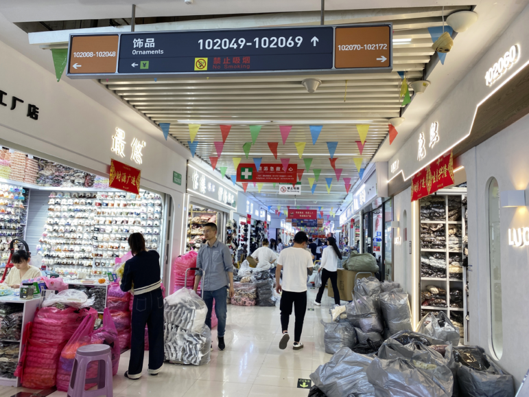 People walk through a building in Yiwu International Trade City, a massive wholesale market in Yiwu, China, where millions of Chinese-made items are sold.