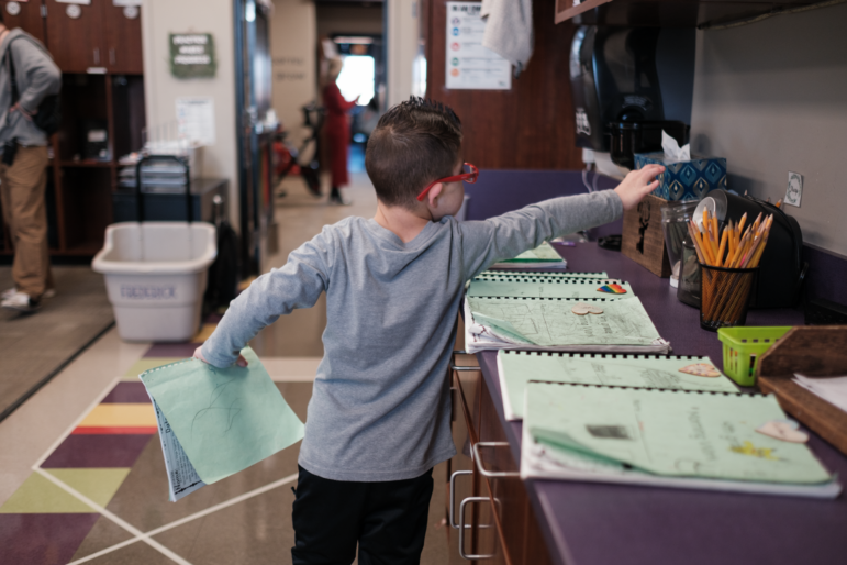 Kellen Hedler prepars to start his school day at Frontier Elementary School in Edmond, Okla.