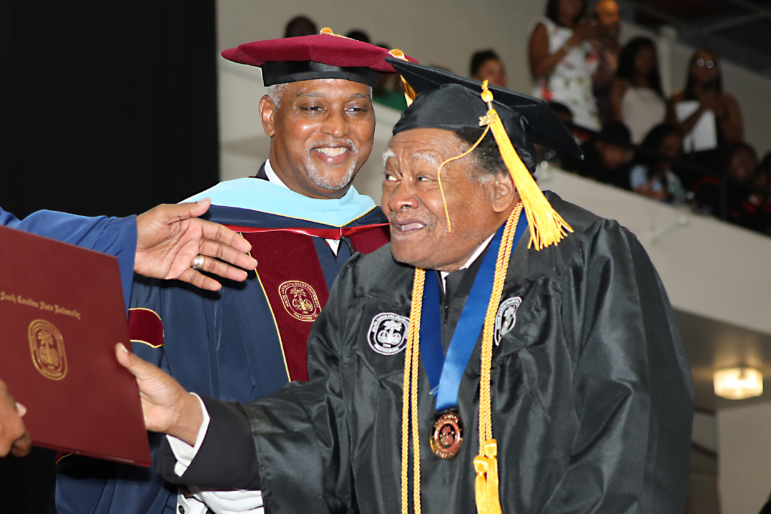 Linwood Riddick, who turns 80 on Monday, is seen accepting his bachelor's degree at South Carolina State University on Friday.