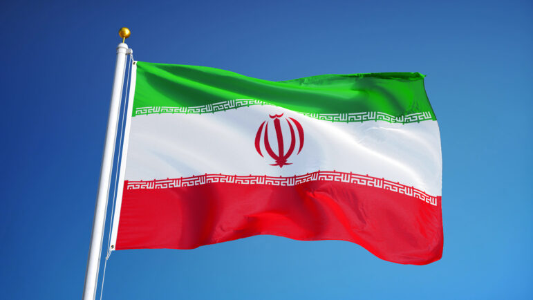 Iran flag waving against clean blue sky