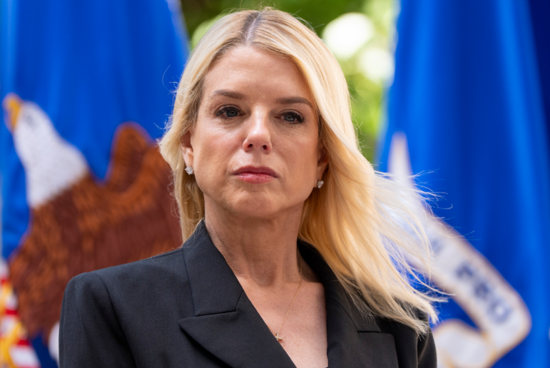 Attorney General Pam Bondi listens during a news conference at the Department of Justice, Wednesday, May 7, 2025, in Washington. In late April, the DOJ's Department of Justice Programs cancelled hundreds of public safety grants to local police and non-profits, leaving many to scramble to replace the funding. Many are appealing the cuts. (AP Photo/Alex Brandon)