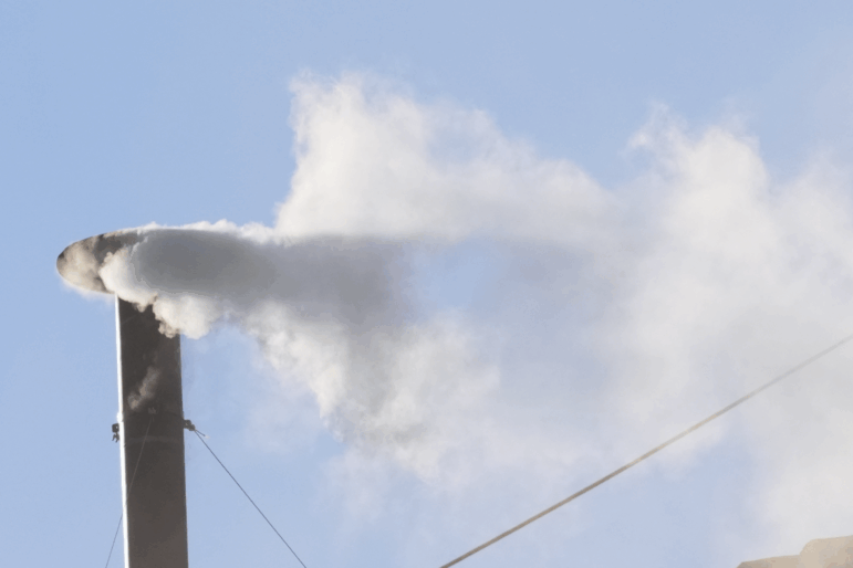 White smoke billows from the chimney of the Sistine Chapel during the conclave to elect a new pope, at the Vatican, Thursday.